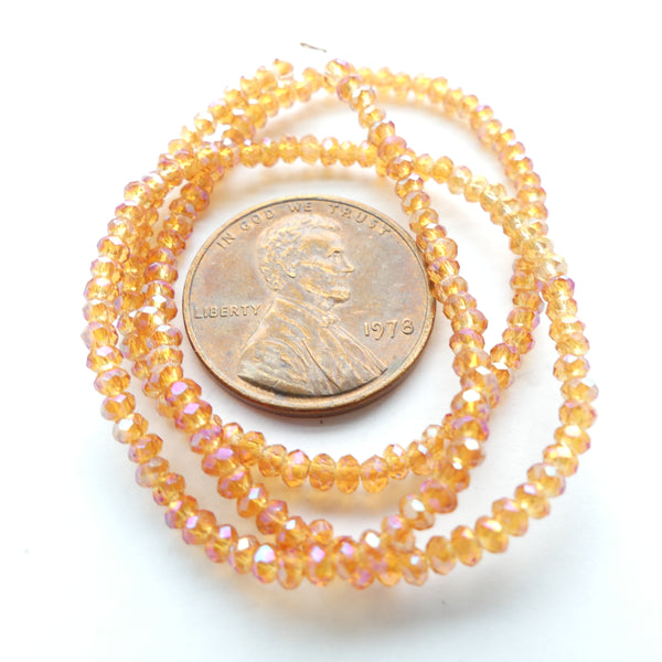 Faceted Glass, "Dragon Crystal" 1x2mm Translucent Orange AB on 12-inch Strands